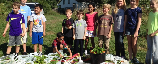 Kids w/ bags of vegetables