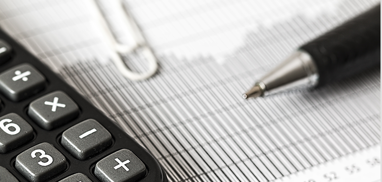 Calculator and pen on table